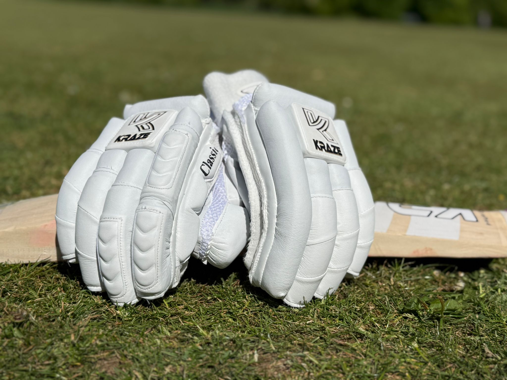Kraze premium test gloves resting on a bat