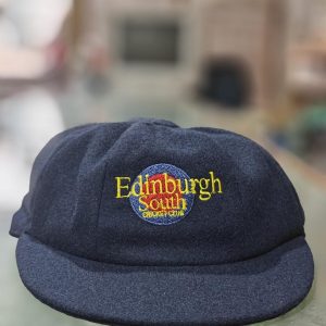 A baggy blue cap with the escc logo