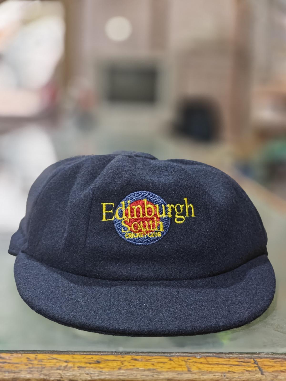 A baggy blue cap with the escc logo