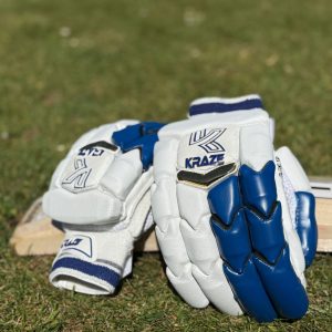 A pair of youth gloves resting on a bat