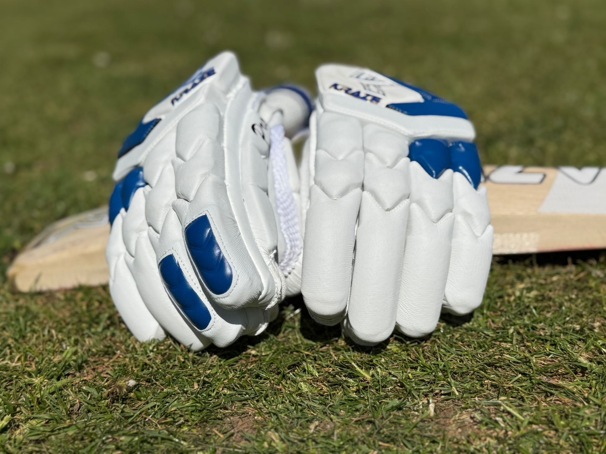 A pair of kraze gloves resting on a bat
